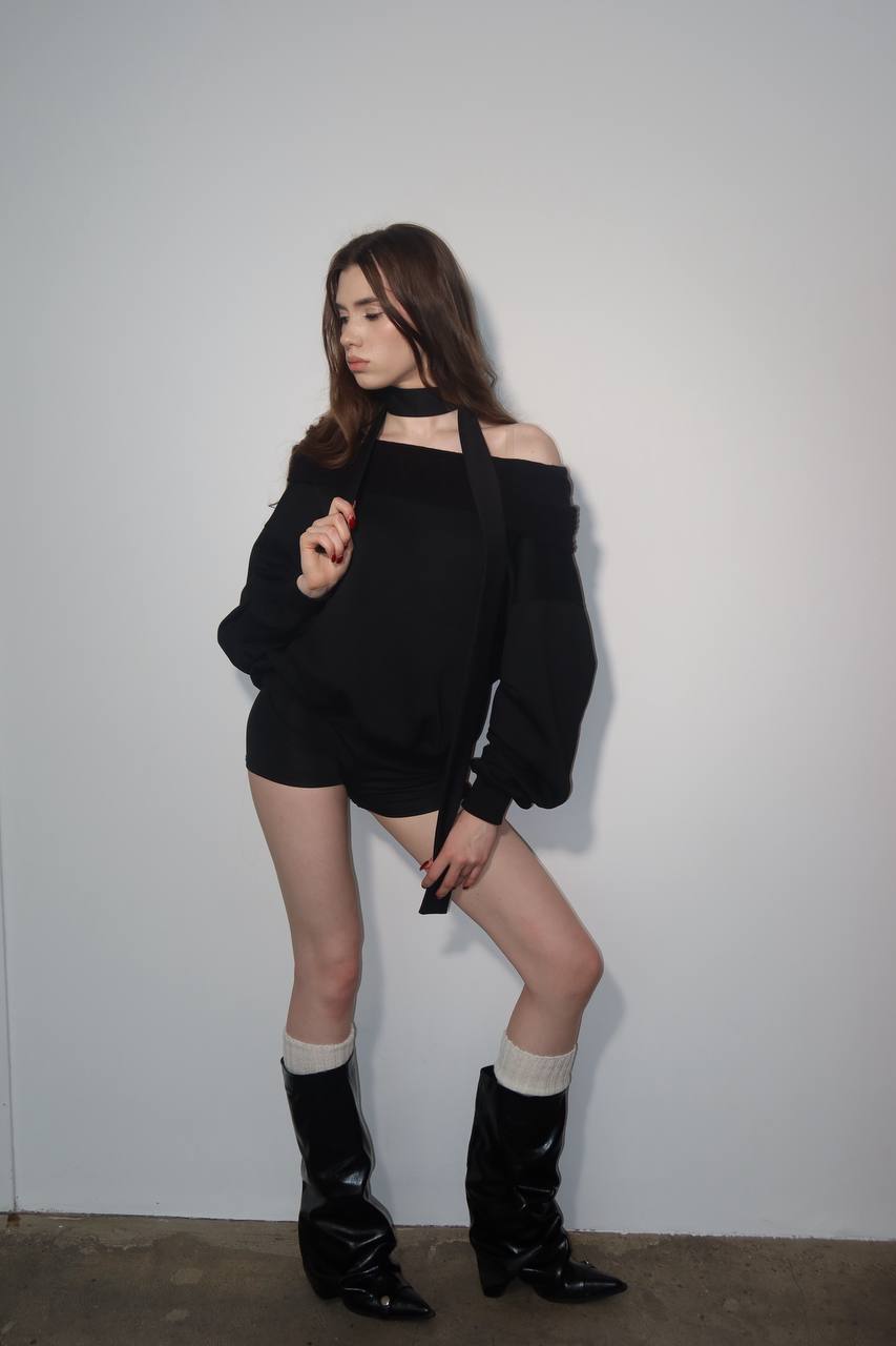 Ultra realistic full body portrait of a tall slim brunette fashion model wearing a stylish black outfit with leather boots in a minimal white studio, luxury editorial photography, soft lighting, realistic skin texture, 8k.