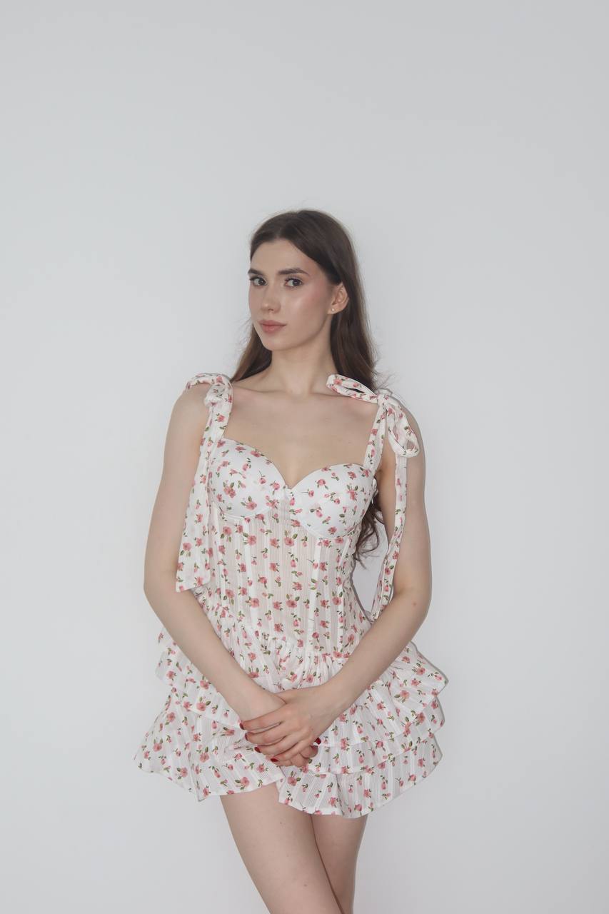 Ultra realistic full body portrait of a beautiful brunette woman with long dark wavy hair wearing a romantic floral mini dress against a clean white studio background, elegant fashion photography, realistic skin texture, 8k.