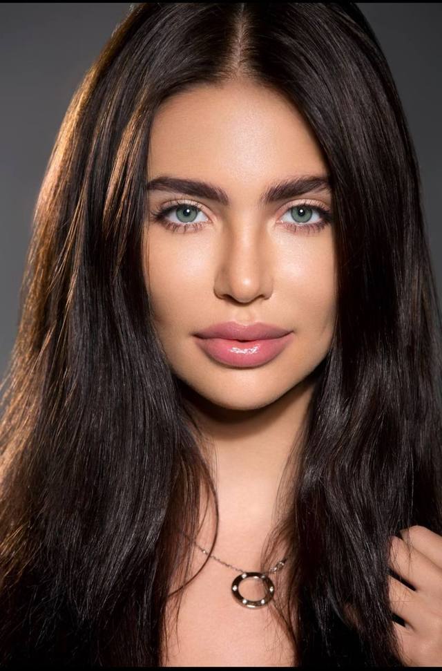 Ultra realistic beauty portrait of a stunning woman with long dark brown glossy hair, mesmerizing emerald green eyes, flawless porcelain skin, full natural lips, perfectly shaped eyebrows, soft studio lighting, luxury skincare campaign, high-end beauty editorial, extremely detailed, 8K.