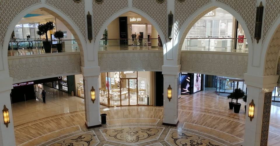 Luxury shopping mall interior with Arabic-style arches, marble floors and lantern lighting in Dubai