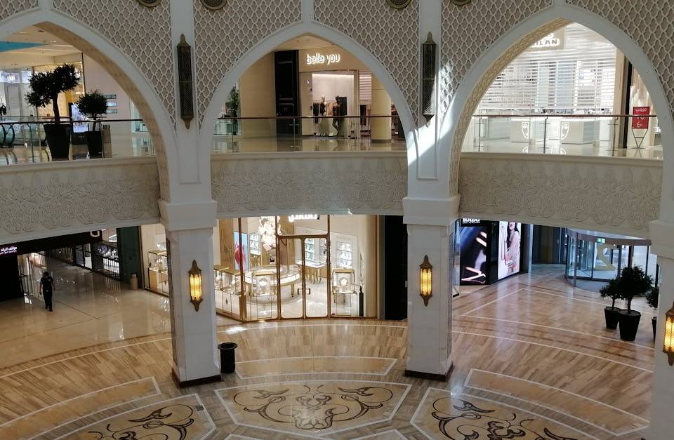 Luxury shopping mall interior with Arabic-style arches, marble floors and lantern lighting in Dubai